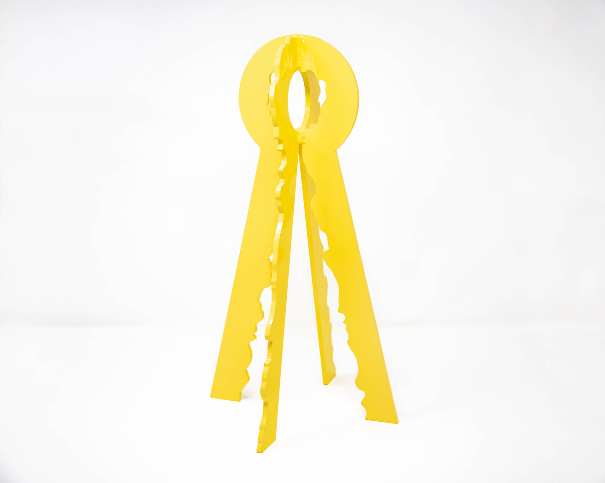 Yellow steel sculpture in the shape that looks like a keyhole.